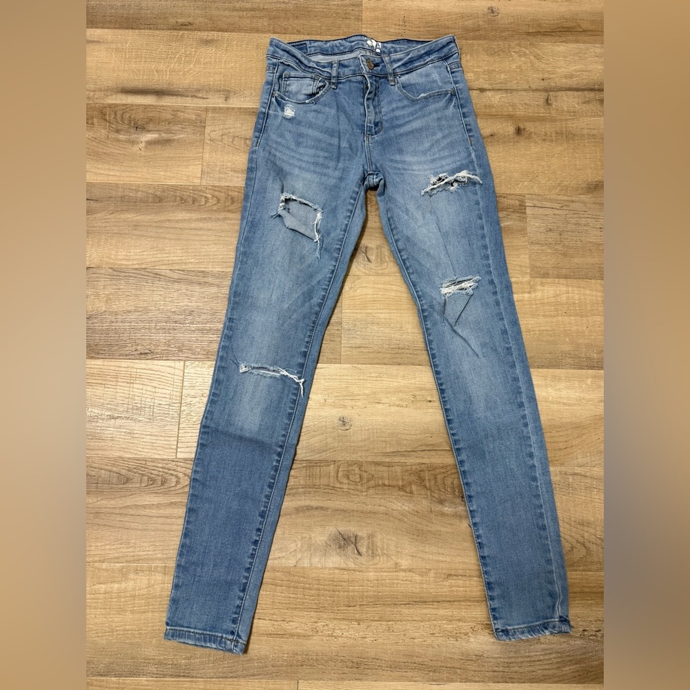 Distressed ripped medium wash denim jeans